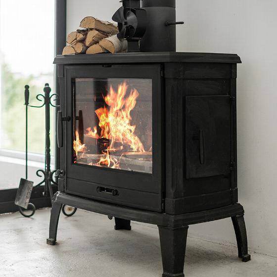 row of residential rooftops with chimneys showing urban architecture and design in a neighborhood with at least five rooftops visible